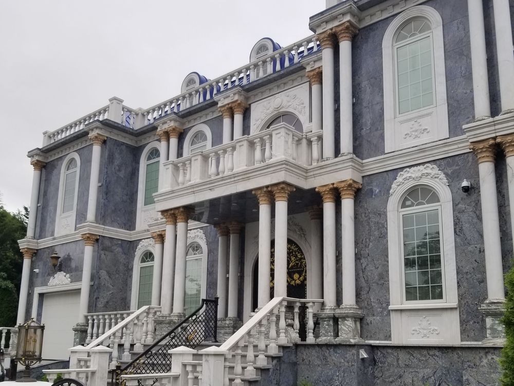 Marble-clad estate with tall arched windows treated by Pellikal