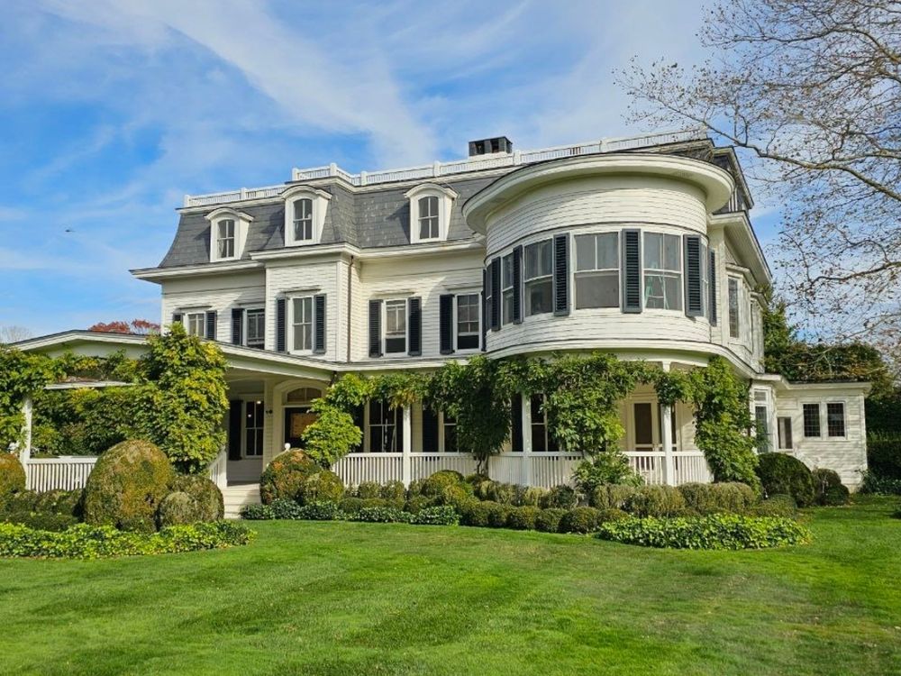 Classic shingled East End home with a wraparound porch and multiple glazed elevations