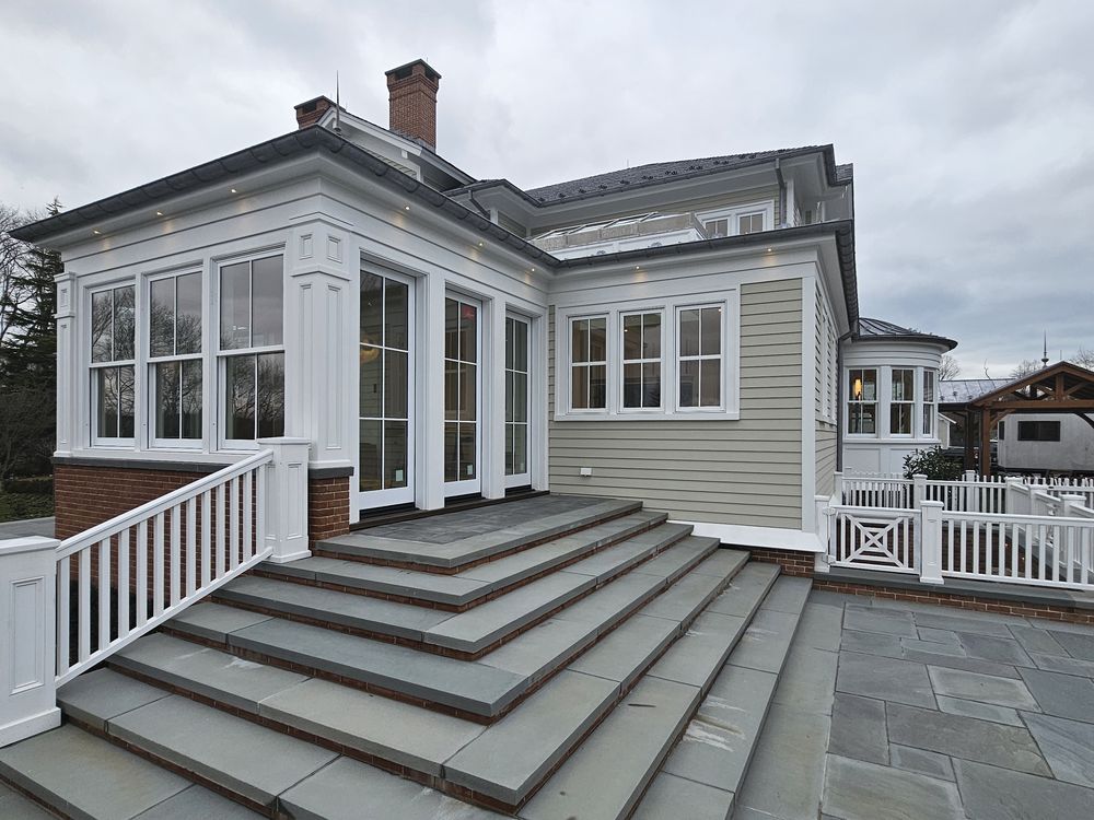 Sunroom glazing above a bluestone terrace at a Pellikal client&rsquo;s home